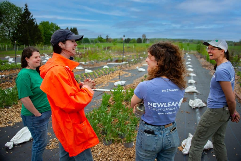 Kelly of Arthurs Point Farm and New Leaf Team Meet at Plant Nursery APF Orange Jacket